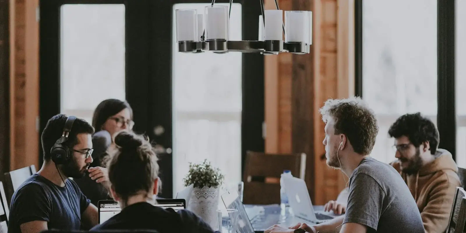 A team working together at laptops around a table