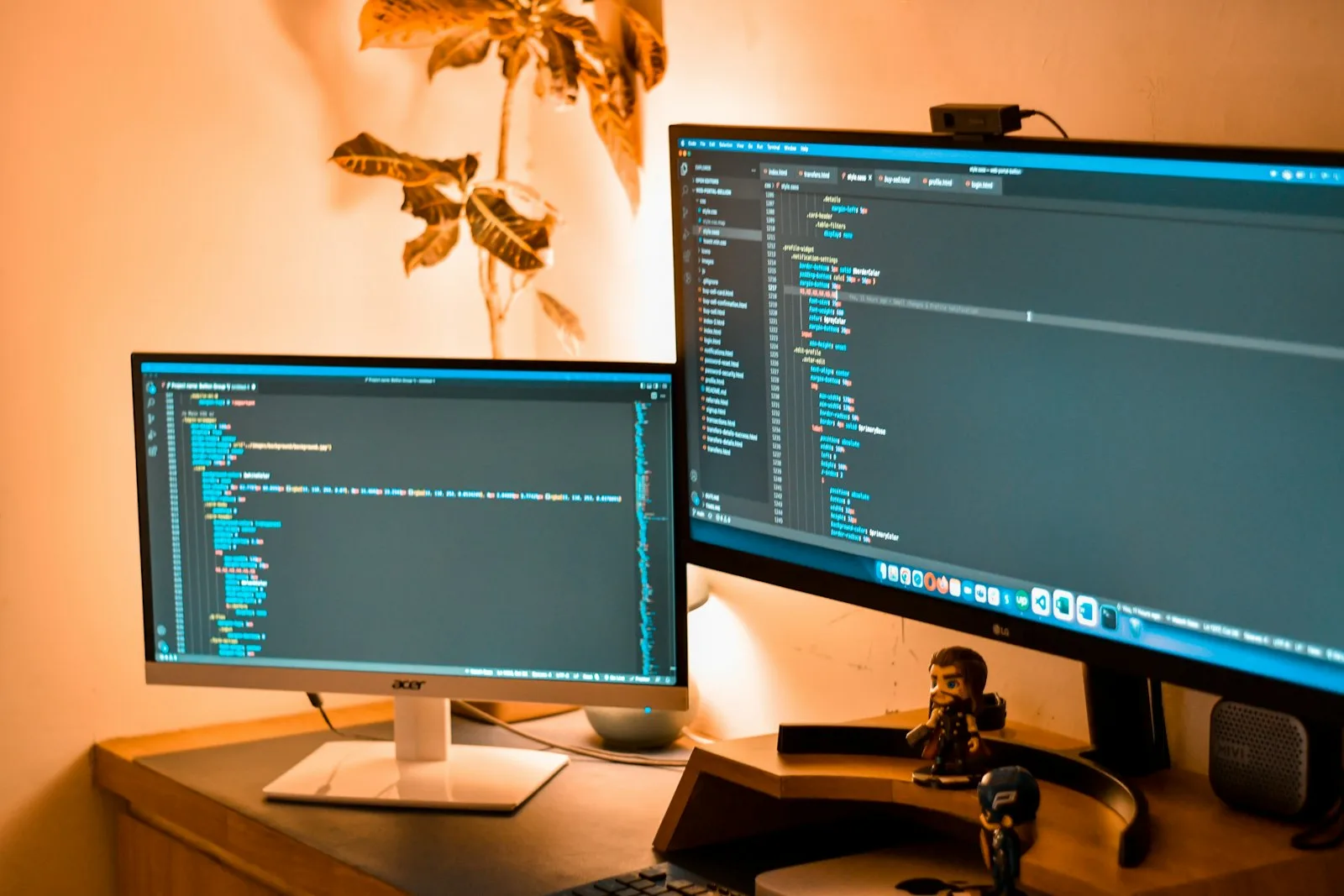A dual-monitor developer workstation displaying code
