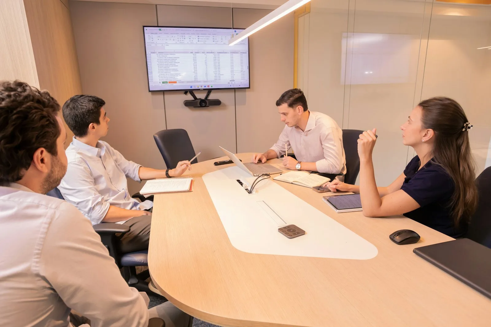 A business meeting with people gathered around a conference table